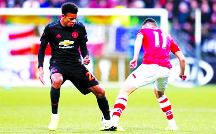 Manchester United's Mason Greenwood (left) tackles his AZ Alkmaar opponent in the UEFA Europa League match between Manchester United and AZ Alkmaar at The Hague on Thursday.