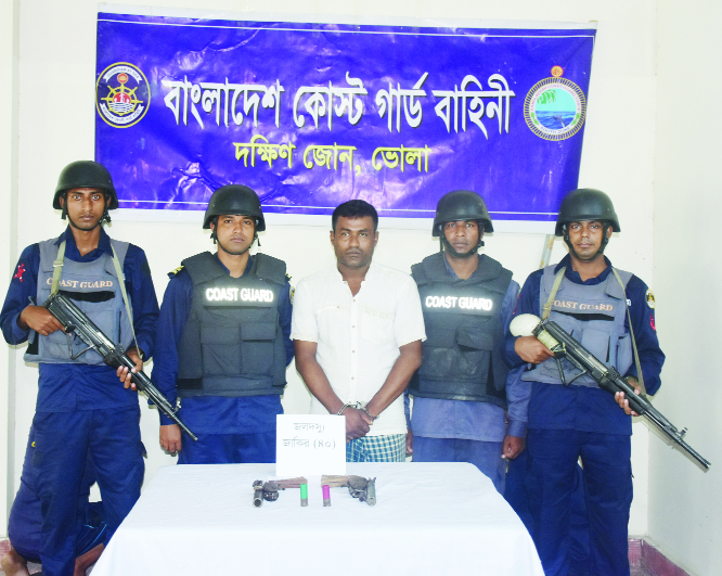 BHOLA: Members of Coast Guard, South Zone arrested robber Jakir , ring leader of dacoit Jakir Bahini with arms from Guptomunshiporakganj area in Bhola yesterday..