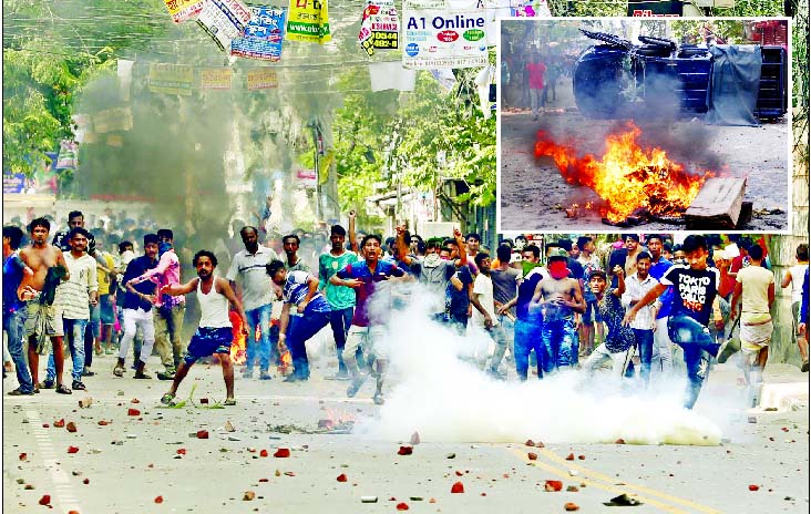 Residents of Mohammadpur Geneva Camp known as Urdu speaking non-Bengalee seen pelting brick chips and stones as they locked into a clash with police on Saturday over electricity bill dispute, leaving 50 injured, including 20 policemen. (Inset) A police va