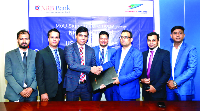 Mir Shafiqul Islam, Head of Cards of NRB Bank Limited and Md Shafiqul Islam, Head of Marketing & Sales of US-Bangla Airlines, exchanging documents after signing an agreement at the bank's head office on Sunday. Under the deal, NRB Bank debit and credit c