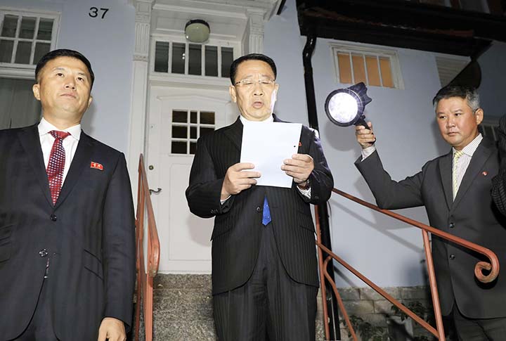 North Korean negotiator Kim Miyong Gil,( Center), reads statement outside the North Korean Embassy in Stockholm, Sweden on Saturday.