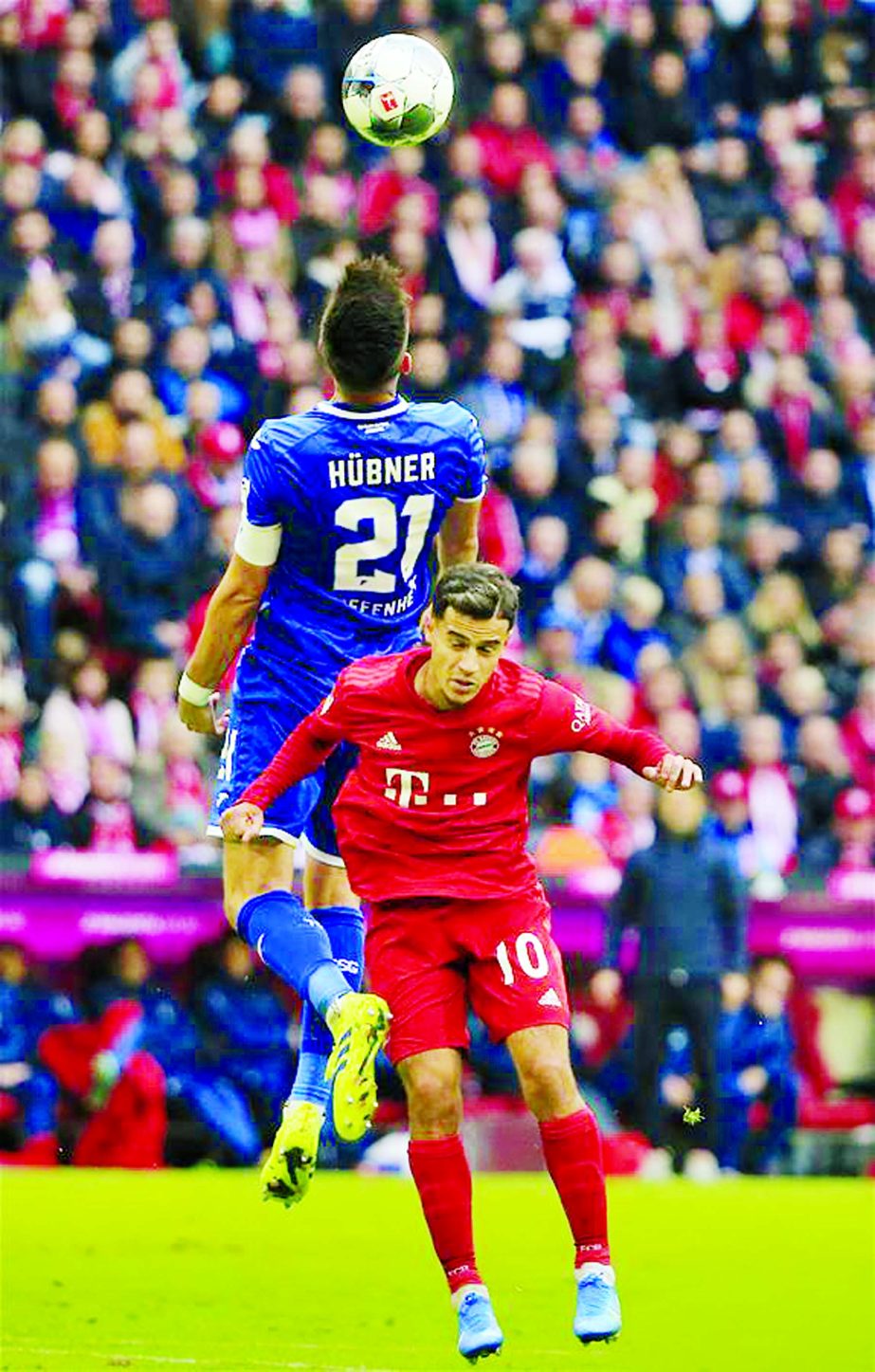 FC Bayern Munich's Philippe Coutinho (down) vies with Benjamin Hubner of Hoffenheim during the Bundesliga soccer match between FC Bayern Munich and TSG 1899 Hoffenheim in Munich, Germany on Saturday.