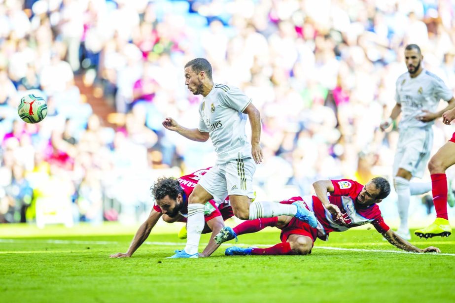 Real Madrid's Eden Hazard scores during the Spanish La Liga soccer match between Real Madrid and Granada at the Santiago Bernarbeu stadium in Madrid on Saturday.