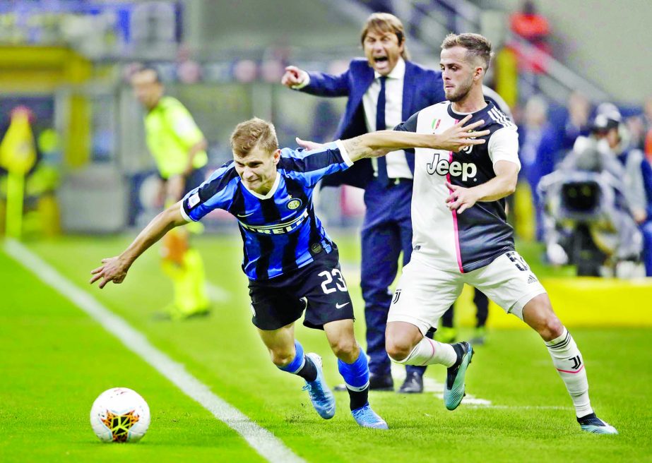 Inter Milan's Nicolo Barella(left) fights for the ball with Juventus' Miralem Pjanic during a Serie A soccer match between Inter Milan and Juventus, at the San Siro stadium in Milan, Italy on Sunday.