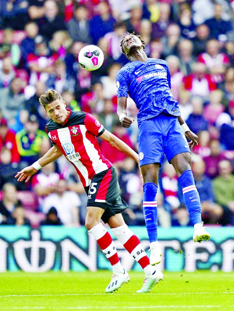 Southampton's Jan Bednarek( left) and Chelsea's Tammy Abraham battle for the ball during the English Premier League soccer match at St Mary's Stadium, Southampton, England on Sunday.