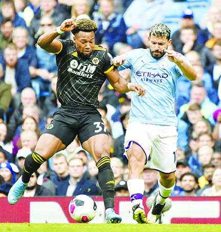 Manchester City's Sergio Aguero(right) and Wolverhampton Wanderers' Adama Traore battle for the ball during the English Premier League soccer match between Manchester City and Wolverhampton Wanderers at Etihad stadium in Manchester, England on Sunda