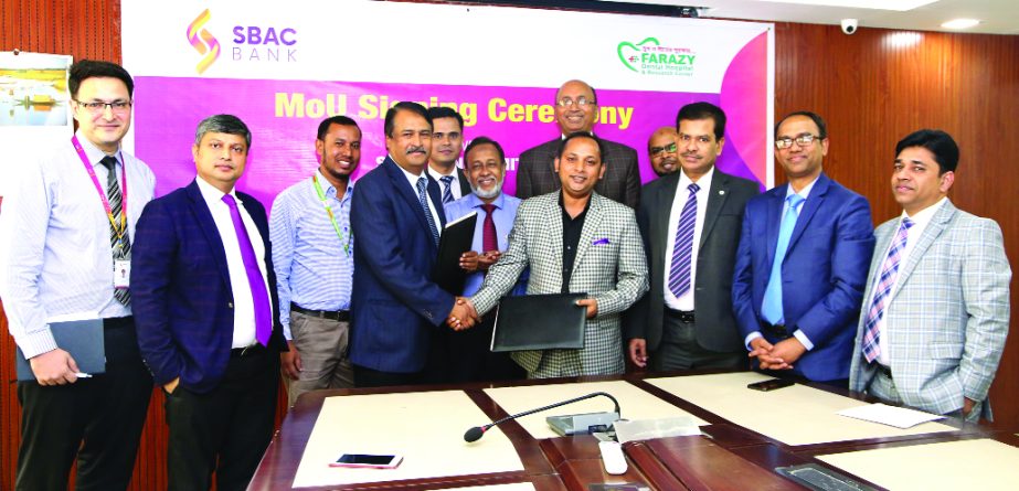 Tariqul Islam Chowdhury, DMD of South Bangla Agriculture and Commerce (SBAC) Bank Limited and Dr Anower Farazy Emon, Chairman of Farazy Hospital Limited, exchanging documents after signing a MoU at the bank's head office in the city recently. Under the d