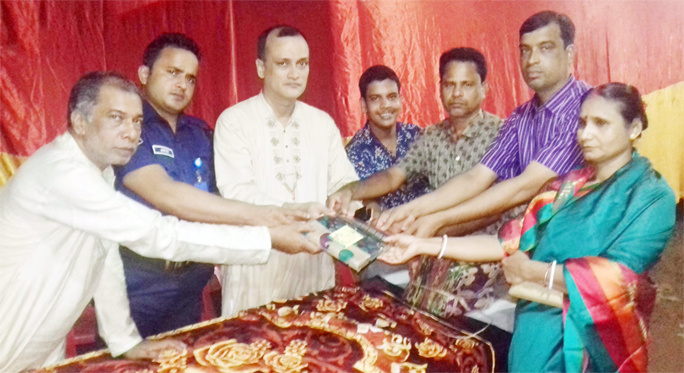 Awami League leader Sadat Anwar Sadi distributing clothes among the distressed marking the Durga Puja in Fatikchhari recently.