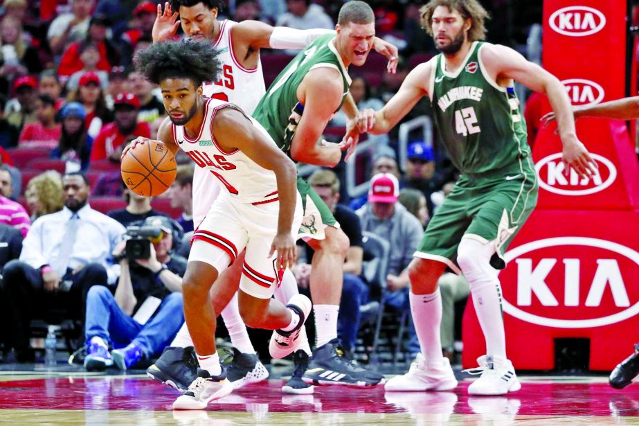 Chicago Bulls guard Coby White (0) leads a fast break during the first half of an NBA preseason basketball game against the Milwaukee Bucks in Chicago on Monday.