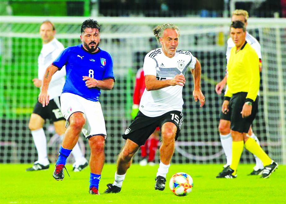 Maurizio Gaudino (right, front) of DFB All Stars, vies with Gennaro Gattuso of Azzurri Legends, during the soccer match between DFB All Stars and Azzurri Legends in Furth, Germany on Monday. The match ended 3-3.