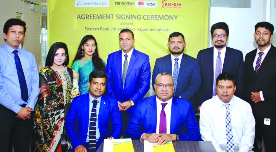 M Khorshed Anowar, Head of Retail and SME Banking of Eastern Bank limited (EBL), poses along with Muhammad Zahidul Hoque, CEO of Bio-Xin Cosmeceuticals, for photograph after signing an agreement at the bank's head office at Gulshan in the capital recentl