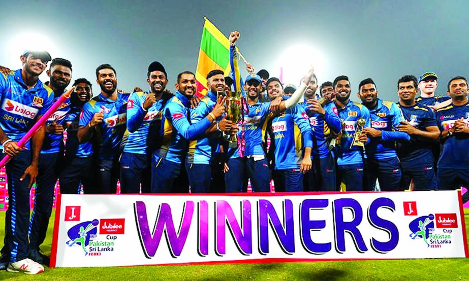 Sri Lanka's cricketers pose for a photograph with winning trophy during the third and final Twenty20 International cricket match between Sri Lanka and Pakistan at the Gaddafi Cricket Stadium in Lahore on Wednesday.