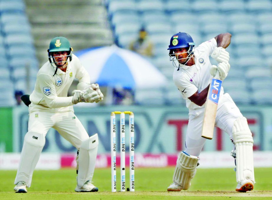 India's Mayank Agarwal (right) bats during the second cricket Test match between India and South Africa in Pune, India on Thursday.