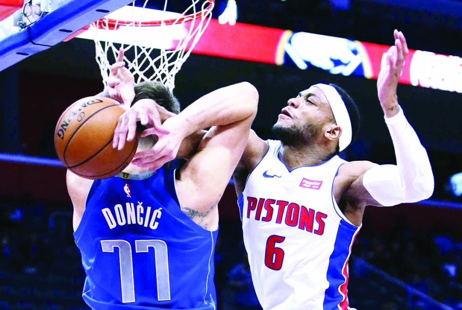 Dallas Mavericks forward Luka Doncic (77) is fouled by Detroit Pistons guard Bruce Brown (6) while going to the basket during the second half of an NBA preseason basketball game on Wednesday.
