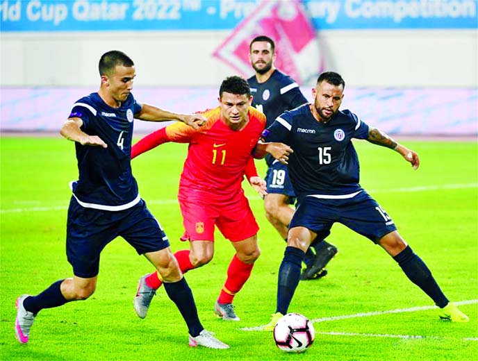 Al Kesen (centre) of China, competes during the group A match between China and Guam at the FIFA World Cup Qatar 2022 and AFC Asian Cup China 2023 Preliminary Joint Qualification Round 2 in Guangzhou, capital of south China's Guangdong Province on Thursd