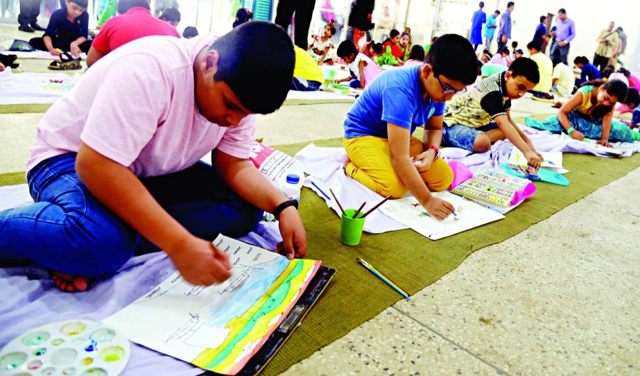 Wards of the members of the Jatiya Press Club engrossed in painting at a drawing competition in the auditorium of the club on Saturday marking the founding anniversary of the club.