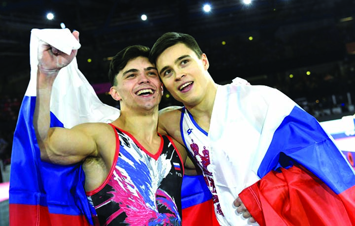 New world champion Nikita Nagornyy (R) celebrates with Artur Dalaloyan (L) as Russia won gold and silver in the men's all-around event at the world gymnastics championships on Friday.