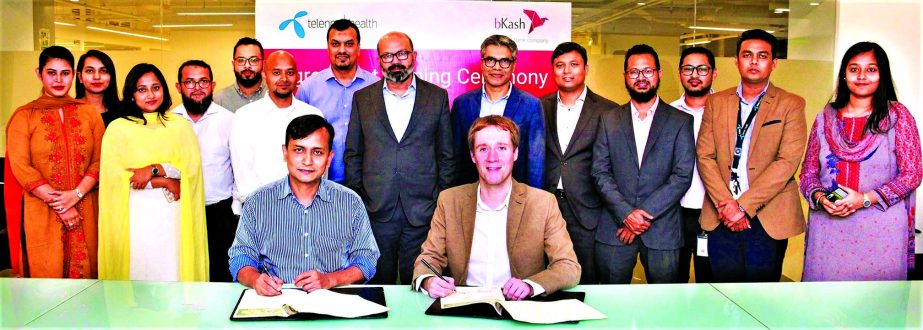 Andrew Smith, Chief Commercial Officer of Telenor Health and Mizanur Rashid Chief Commercial Officer of bKash Limited, signing an agreement at bKash's corporate office in the city recently.