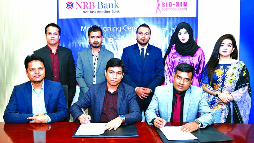 Mir Shafiqul Islam, Head of Cards of NRB Bank Limited and Muhammad Zahidul Hoque, CEO of Bio-Xin Cosmeceuticals, exchanging an agreement signing document at the bank's head office in the city recently. Under the deal, Debit and Credit Cardholders of the