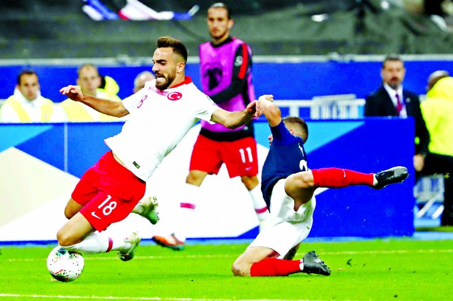 France's Lucas Hernandez (right) fights for the ball with Turkey's Kenan Karaman during the Euro 2020 group H qualifying soccer match between France and Turkey at Stade de France at Saint Denis, north of Paris, France on Monday.
