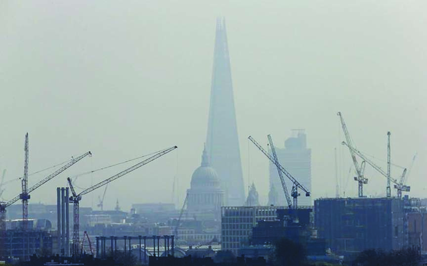 Smog surrounds The Shard, western Europe's tallest building, and St Paul's Cathedral in London.
