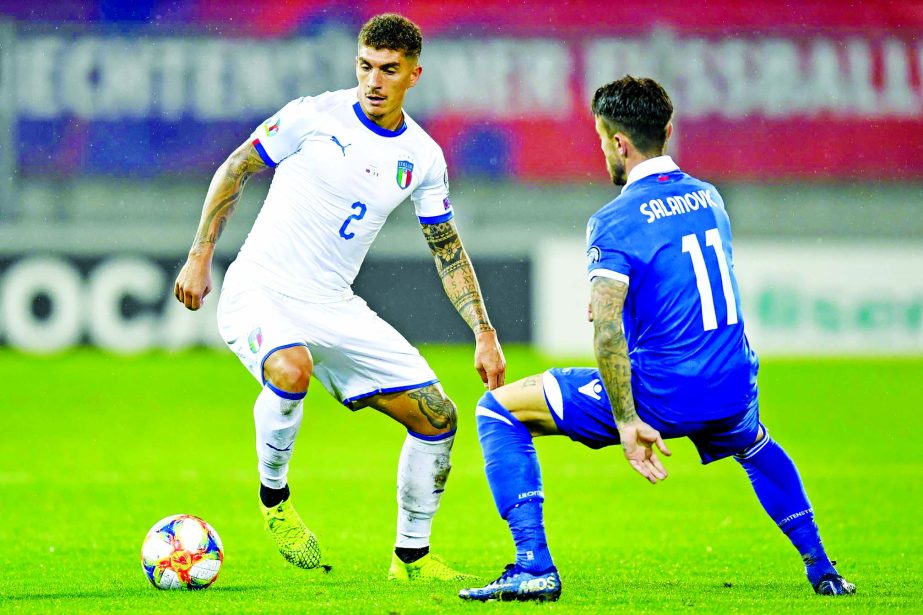 Italy's Giovanni Di Lorenzo (left) controls the ball against Liechtenstein's Dennis Salanovic during their Euro 2020 Qualifying, Group J soccer match in Vaduz, Liechtenstein on Tuesday.