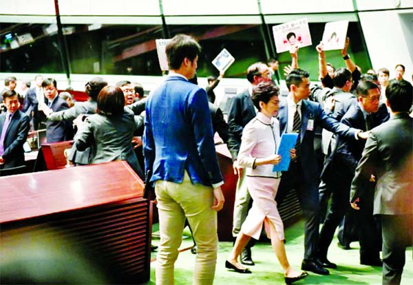 There were chaotic scenes inside Hong Kong's legislature as the city's leader tried to deliver a policy address.