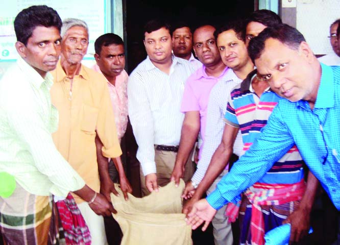 SAGHATA (Gaibandha): Mohiuddin Jahangir, UNO, Saghta Upazila distributing VGF rice among the fishermen to pass Hilsa ban period on Tuesday.