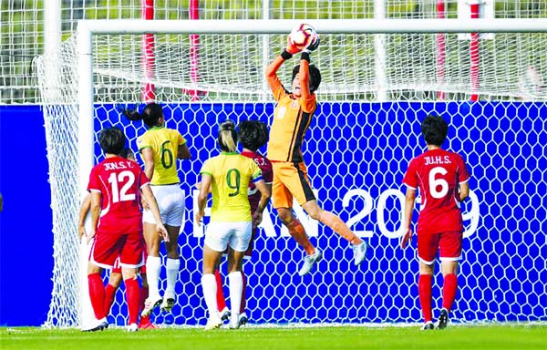 Kim Myong Sun (2nd from right) of the Democratic People's Republic of Korea, (DPRK) saves the ball during a women's football first round match between DPRK and Brazil at the 7th International Military Sports Council (CISM) Military World Games in Wuhan,