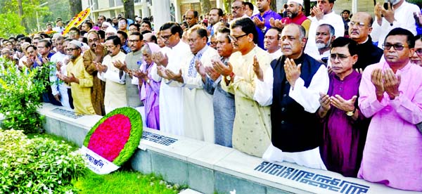 Awami League General Secretary and Road Transport and Bridges Minister Obaidul Quader along with party colleagues offering munajat after placing floral wreaths on the grave of Sheikh Russel in the city's Banani graveyard on Friday marking the 56th birthd
