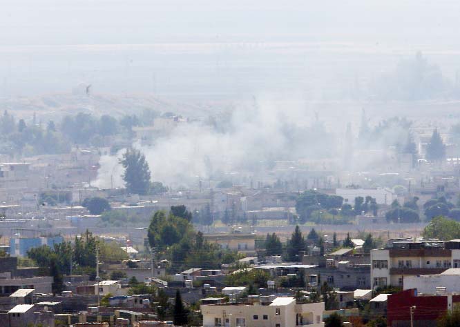 Smoke billows from targets in Ras al-Ayn, Syria, caused by shelling by Turkish forces on Friday