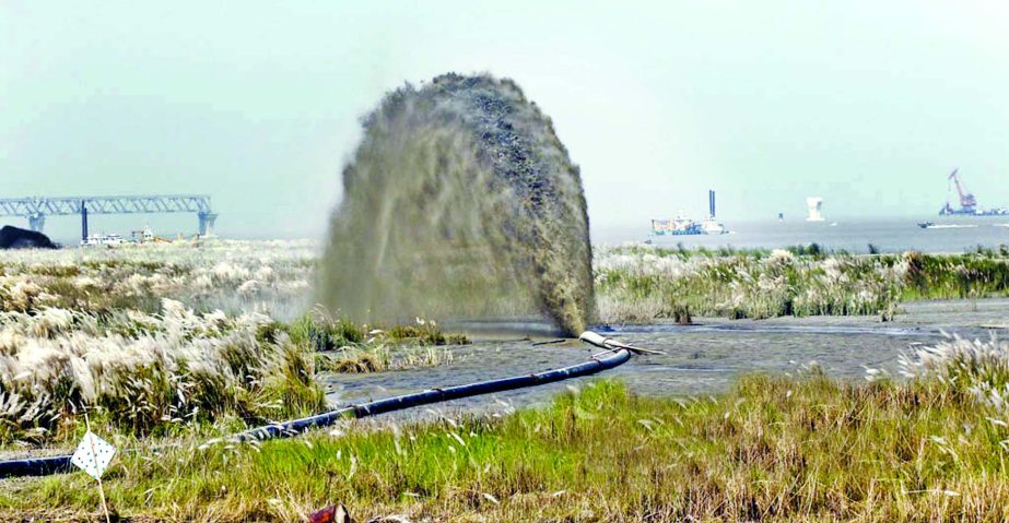 Dredging is going on in a channel of River Padma after ferry services between Shimulia and Kathalbari terminal faces setback due to poor navigability in a stretch of the river. This photo was taken from Shimulia in Madaripur on Friday.