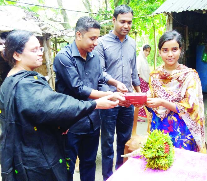 BHANGURA (Pabna): Syed Asrafuj Jaman, UNO greetings Trisha Parvin on Friday who got chance in the MBBS admission at Habiganj Govt Medical College recently.