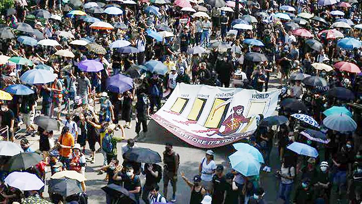 Protesters march in the Tsim Sha Tsui district in Hong Kong on Sunday