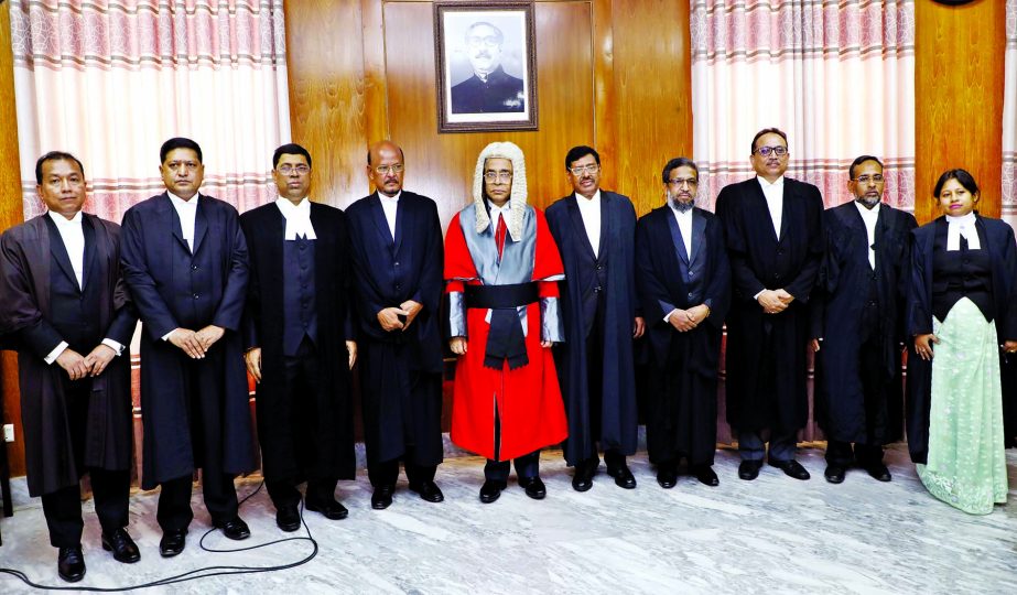 Chief Justice Syed Mahmud Hossain poses for a photo session with the newly appointed nine Additional Judges of the High Court after administering oath at the Judges Lounge of the Supreme Court on Monday.
