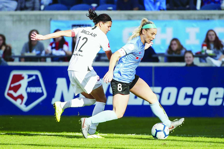 Chicago Red Stars midfielder Julie Ertz (8) defends against Portland Thorns FC forward Christine Sinclair (12) during the second half of an NWSL playoffs semi-final soccer match in Bridgeview, Ill on Sunday.