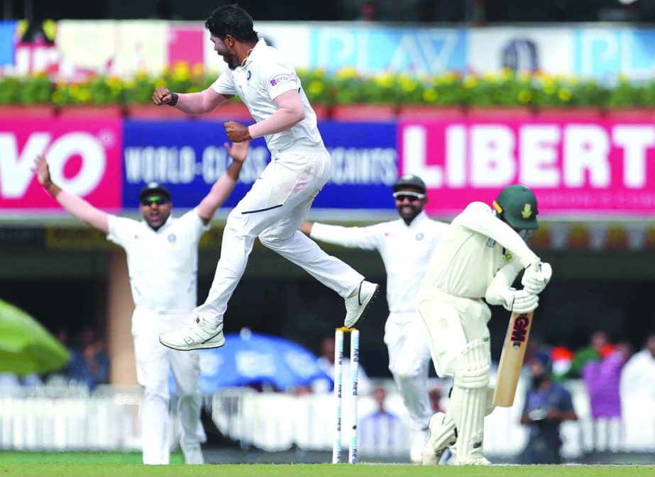 India's Umesh Yadav leaps in the air to celebrate the dismissal of South Africa's Quinton de Kock (right) during the third day of third and last cricket test match between India and South Africa in Ranchi, India on Monday.