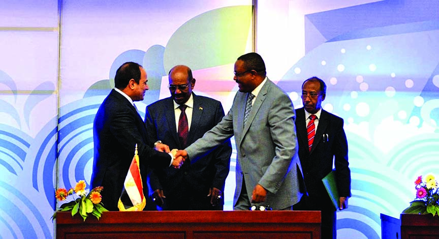 Sudanese President Omar al-Bashir, (centre), Egyptian President Abdel-Fattah el-Sissi, left, and Ethiopian Prime Minister Hailemariam Desalegn, right, hold hands after signing an agreement on sharing water from the Nile River, in Khartoum, Sudan.