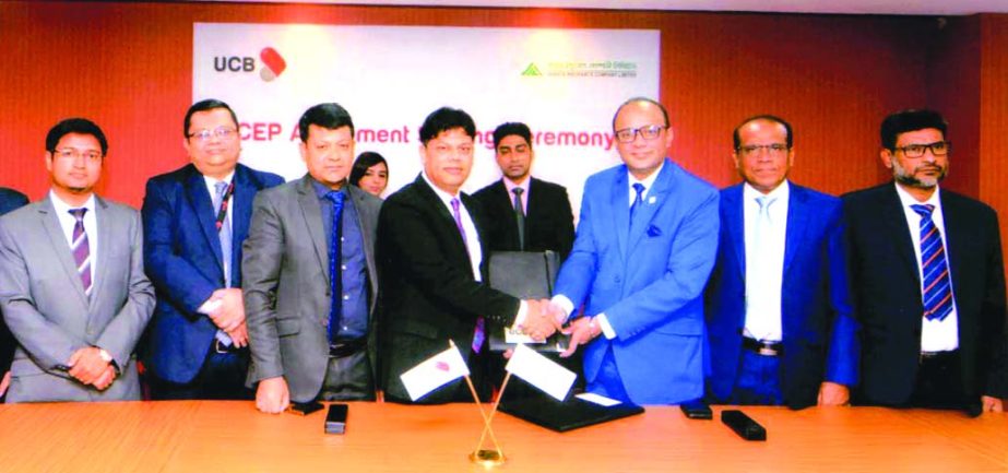 Saadat R. Khan, CEO of Janata Insurance Company Limited and Abul Kalam Azad, Head of National Sales of Retail Banking Division of United Commercial Bank Limited, exchanging documents after signing an agreement on CER at the bank's head office in the city