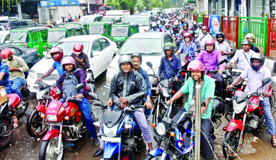 Hundreds of Apps-based motorbikes like Pathao, Uber keep occupied the city streets and footpaths defying traffic rules. But the traffic authorities mostly remain concerned over the chaos. This photo was taken from Bijoy Sarani Point.