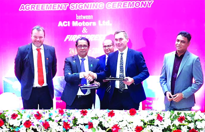 Dr. F H Ansarey, CEO of ACI Motors Limited and Henrik Naaby, Managing Director of Firexpress (a Danish fire-fighting system company), exchanging documents after signing an agreement at ACI Centre in the city on Thursday. Under the deal, ACI Motors will be