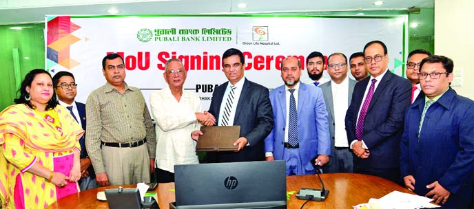 Md. Abdul Halim Chowdhury, Managing Director of Pubali Bank Limited and Dr. Md. Mainul Ahasan, Managing Director of Green Life Hospital Limited, exchanging a MoU signing documents at the bank's head office in the city recently. Under the deal, all card h