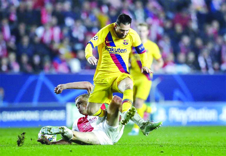 Barcelona's Lionel Messi (top) duels for the ball with Slavia's Tomas Soucek during the Champions League group F soccer match between Slavia Praha and FC Barcelona at the Sinobo stadium in Prague, Czech Republic on Wednesday.