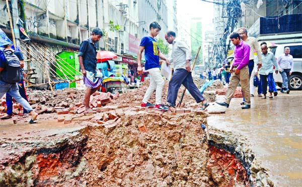 Many city roads have been left undressed after digging for laying underground sewerage pipes, causing huge inconvenience for the pedestrians. This photo was taken on Thursday from in front of Motijheel Police Station.