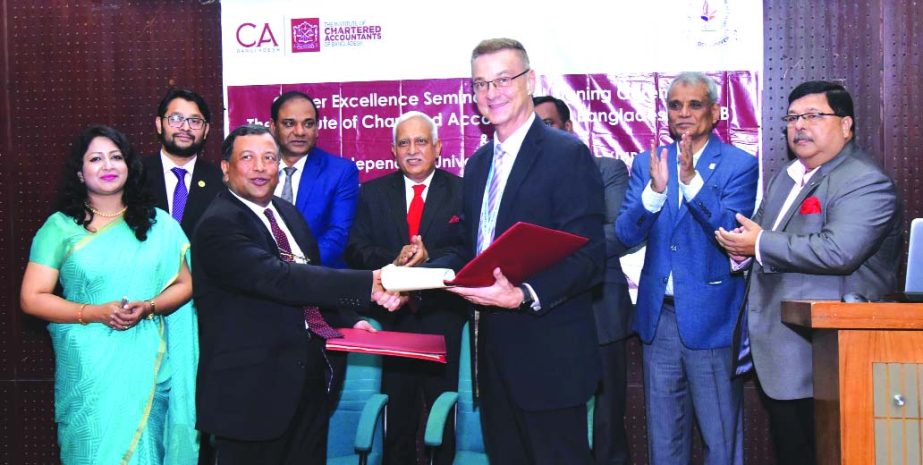 A F Nesaruddin, FCA, President of Institute of Chartered Accountants of Bangladesh (ICAB) and Professor Dr Milan Pagon, Vice Chancellor (Acting) of Independent University, Bangladesh (IUB), exchanging documents after signing a Memorandum of Understanding