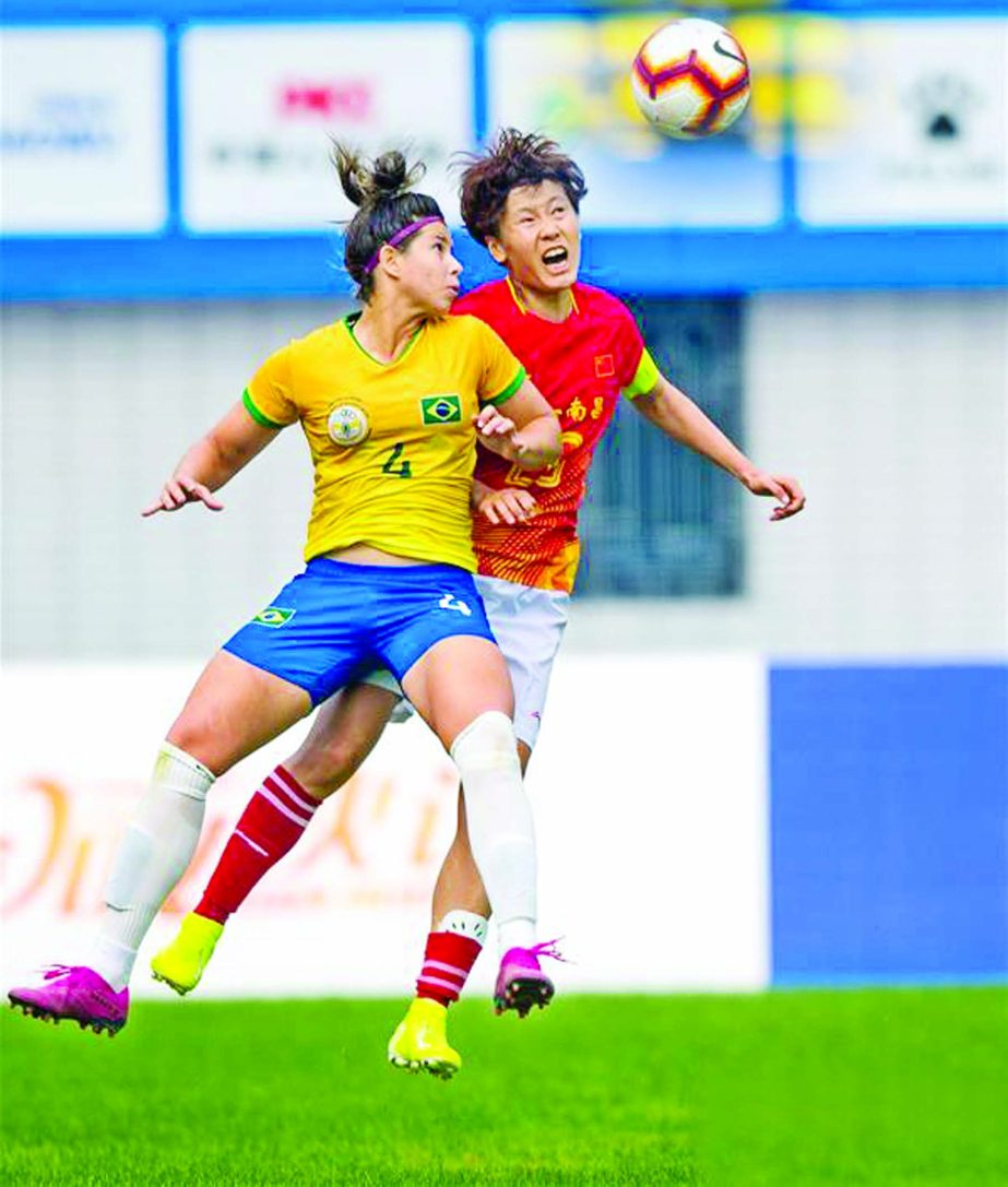 Zhang Rui (R) of China vies with Fernanda Licen of Brazil during the women's football semifinal between China and Brazil at the 7th International Military Sports Council (CISM) Military World Games in Wuhan, capital of central China's Hubei Province on