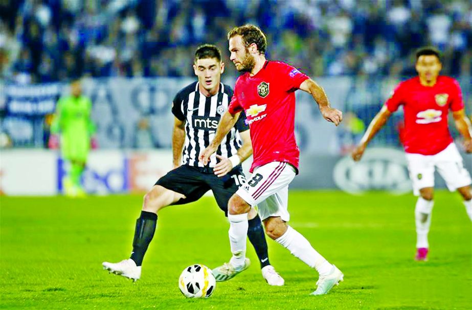 Manchester United's Juan Mata (right) vies with Partizan's Sasa Zdjelar during a UEFA Europa League Group L football match between Partizan and Manchester United in Belgrade, Serbia on Thursday.