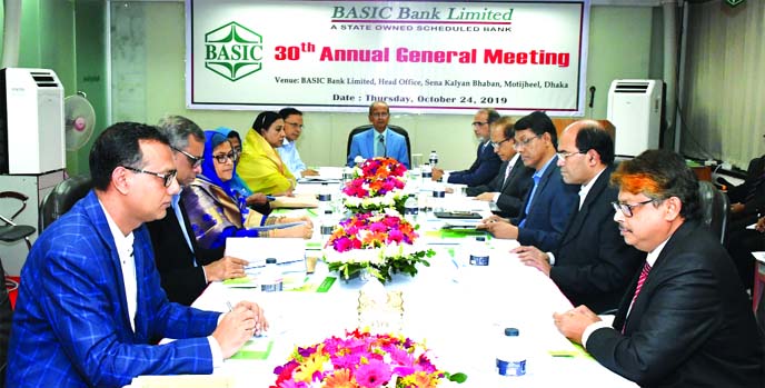 Alauddin A. Majid, Chairman, Board of Directors of BASIC Bank Limited, presiding over its 30th AGM at its head office in the city on Thursday. Arijit Chowdhury, Additional Secretary of Financial Institutions Division of Finance Ministry, Parag, Hasan Mahm