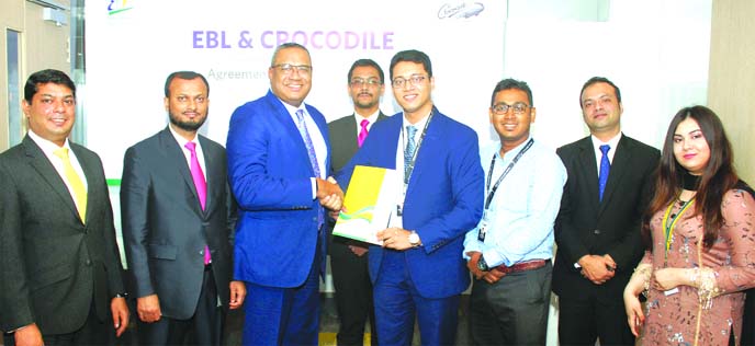 M. Khorshed Anowar, Head of Retail and SME Banking of Eastern Bank Limited (EBL) and Saad Omar Fahim, Managing Director of Crocodile Bangladesh Limited, exchanging documents after signing an agreement at the banks head office in the city recently. Under t