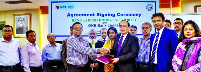 M. Fakhrul Alam, Managing Director of ONE Bank Limited (OBL) and Dr. Md. Moniruzzaman, Director (Finance & Accounts) of Bangladesh Bridge Authority, exchanging documents after signing an agreement at Setu Bhaban in the city recently. Under the deal, OBL w